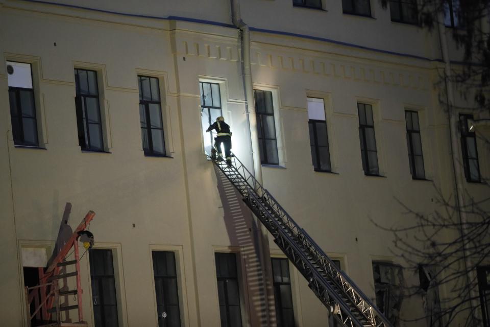 A Russian Emergency employee tries to get inside the collapsed building of the Saint Petersburg National Research University of Information Technologies, Mechanics and Optics in St. Petersburg, Russia, Saturday, Feb. 16, 2019. Russian emergency authorities say several floors of a university building in Russia's second-largest city have collapsed. There was no immediate information on casualties. (AP Photo/Dmitri Lovetsky)