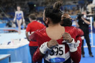 Simone Biles, of United States, right, hugs teammate Sunisa Lee, after pulling out of the women's artistic gymnastic team finals at the 2020 Summer Olympics, Tuesday, July 27, 2021, in Tokyo, Japan. (AP Photo/Gregory Bull)