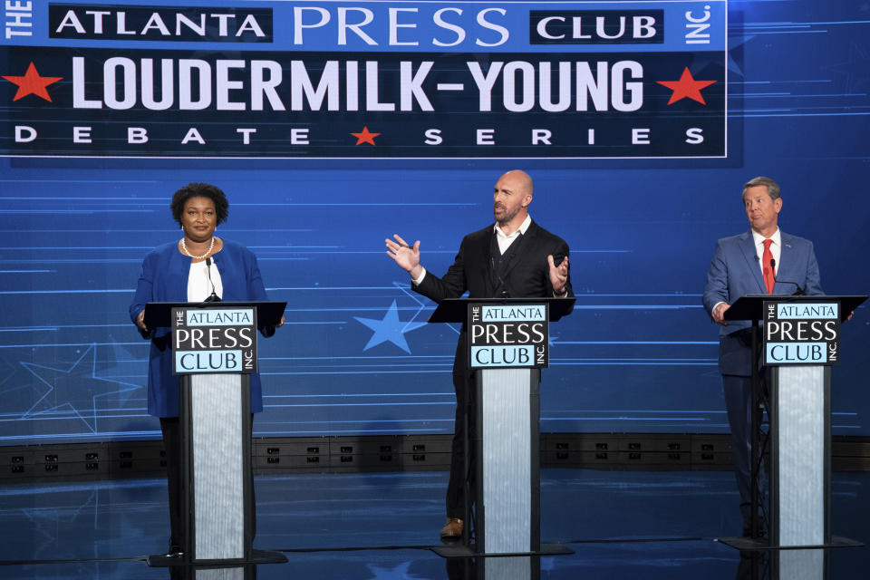 Democratic challenger Stacey Abrams, from left, Libertarian challenger Shane Hazel and Georgia Republican Gov. Brian Kemp debate during the Atlanta Press Club Loudermilk-Young Debate Series in Atlanta, Monday, Oct. 17, 2022. (AP Photo/Ben Gray)