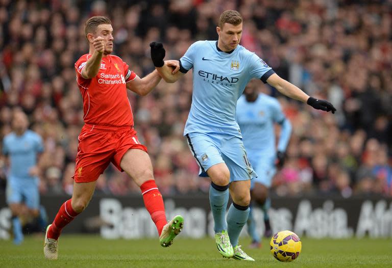 Liverpool's Jordan Henderson (L) and Manchester City's Edin Dzeko during their Premier League match at Anfield on March 1, 2015