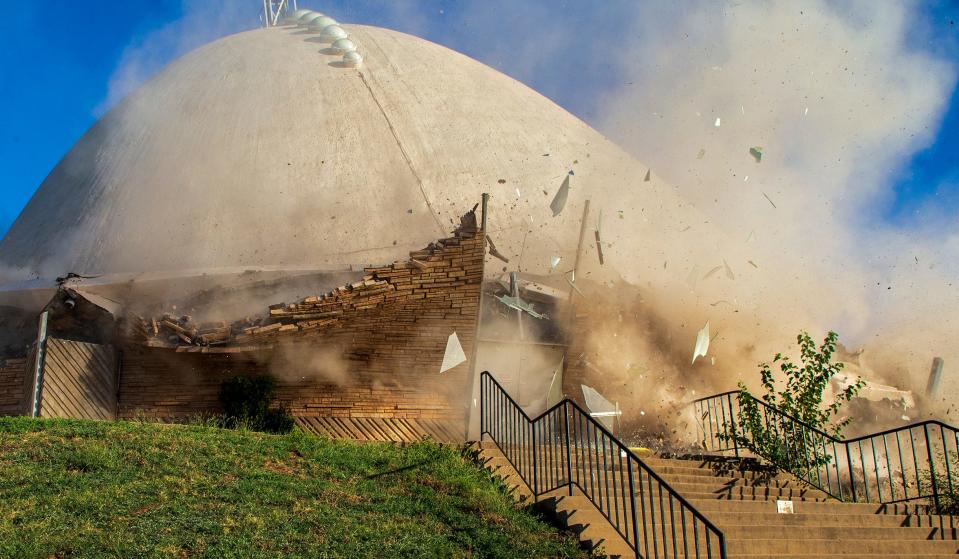 Debris flies through the air Monday, Sept. 26, 2022, as crews work to demolish First Christian Church on NW 36 and Walker Avenue in Oklahoma City.