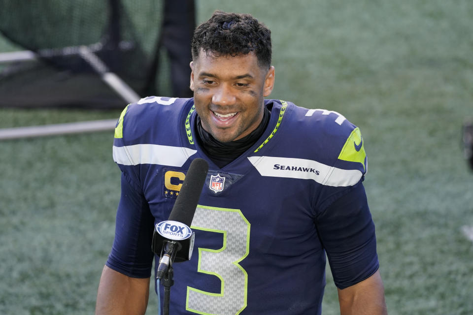 Seattle Seahawks quarterback Russell Wilson smiles during a post-game interview after an NFL football game against the Dallas Cowboys, Sunday, Sept. 27, 2020, in Seattle. The Seahawks won 38-31. (AP Photo/Elaine Thompson)