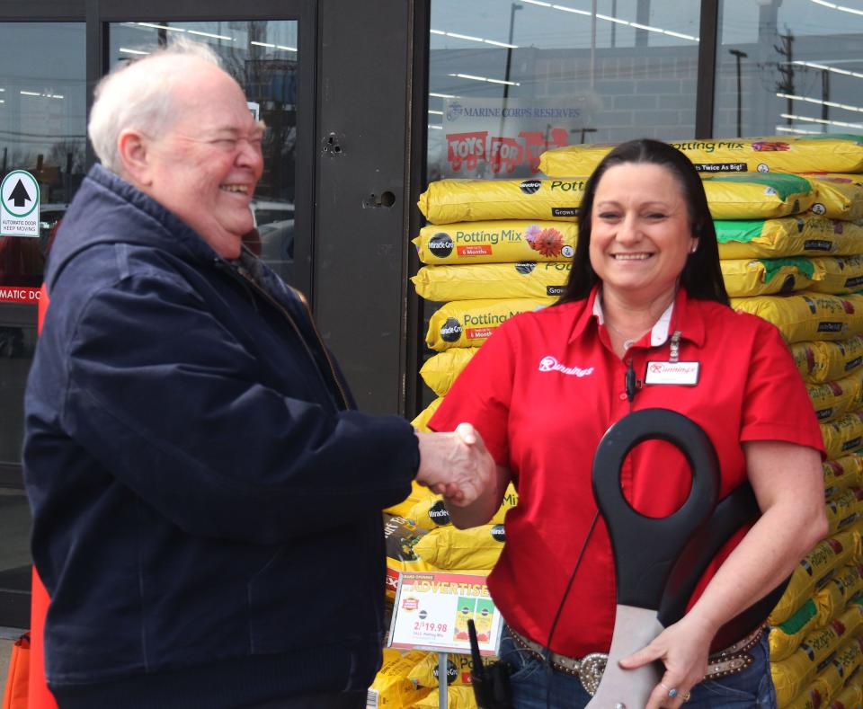 Pontiac Mayor Bill Alvey, left, congratulates Runnings store manager Bridget Reaves at the ribbon cutting for the newly opened Runnings Store at 1027 W. Reynolds St.