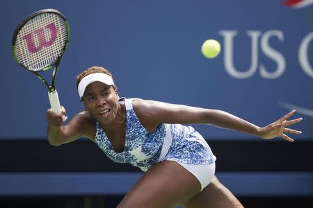 Venus Williams of the U.S. hits a return to Monica Puig of Puerto Rico during their match at the U.S. Open Championships tennis tournament in New York, August 31, 2015. REUTERS/Carlo Allegri