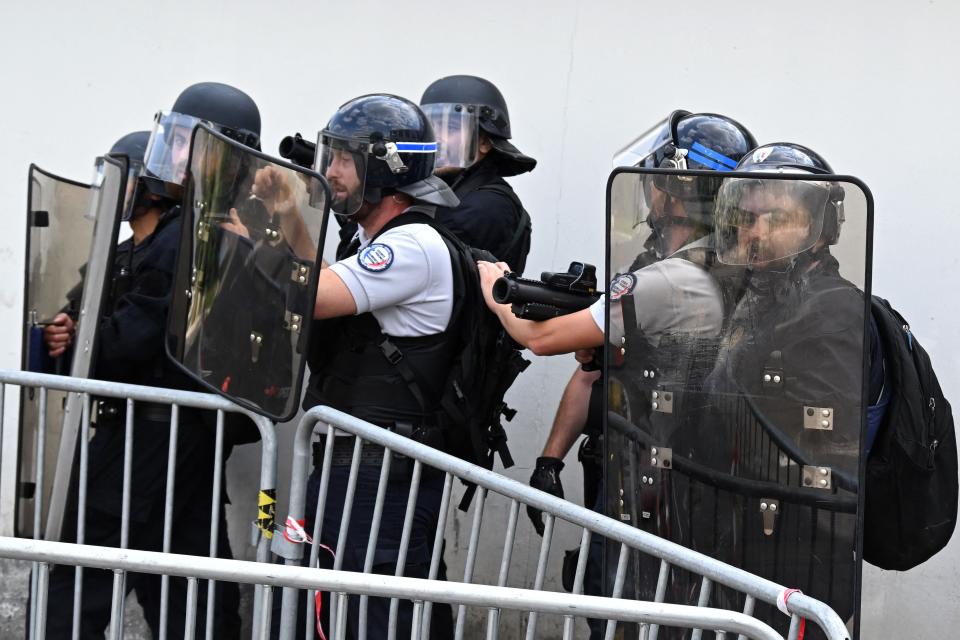 Police officers, one holding a rubber defensive bullet launcher LBD 40 (2nd R), stand guard in front of the shopping centre Rosny 2 in Rosny-sous-Bois, in the eastern suburbs of Paris (AFP via Getty Images)