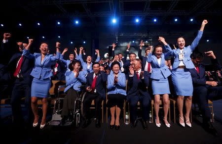 Members of the Beijing delegation celebrate after Beijing was awarded the 2022 Winter Olympic Games, defeating Almaty in the final round of voting, during the 128th IOC session in Kuala Lumpur, July 31, 2015. REUTERS/Olivia Harris