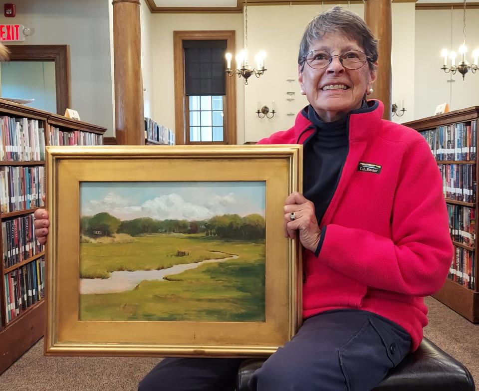 J.P. Goodwin holding a piece of her exhibit at Gafney Library