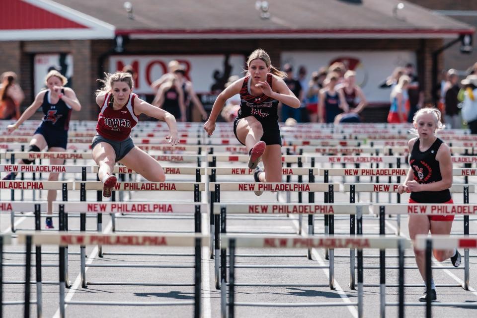 Girls from Tuscarawas County area schools compete in the 100 meter hurdles during the Tuscarawas County Classic Monday at Woody Hayes Quaker Stadium in New Philadelphia.