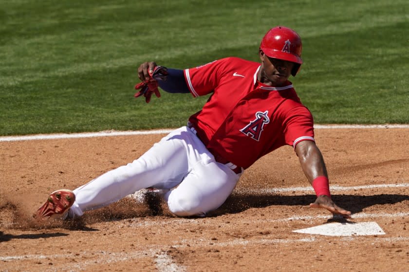 Los Angeles Angels' Justin Upton rounds third to score on a base hit by Kurt Suzuki.