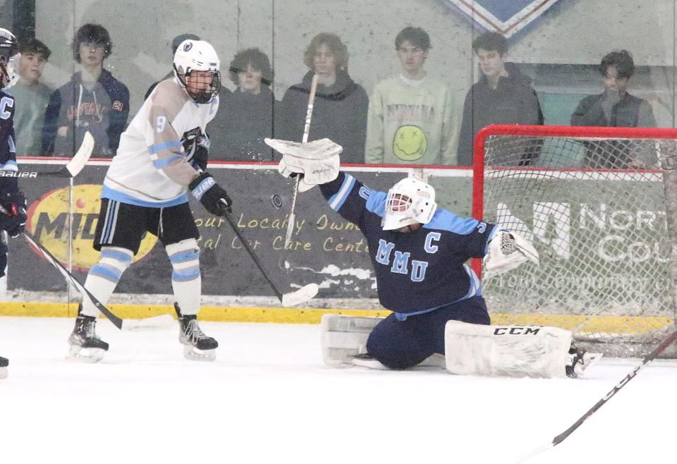 MMU goalie Lucas Parisi uses his stick to block a shot by the Wolves Jules Butler during the Cougars 5-1 loss to South Burlington in the D1 semifinals at Cairns Arena on Saturday afternoon.