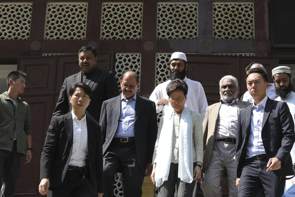 Hong Kong Chief Executive Carrie Lam, center, leaves a mosque in Hong Kong, Monday, Oct. 21, 2019. Lam and other officials apologized to leaders of the Kowloon Mosque after riot police sprayed the building's gate and some people nearby with a blue-dyed liquid from a water cannon as they tried to contain pro-democracy demonstrations Sunday. (AP Photo)