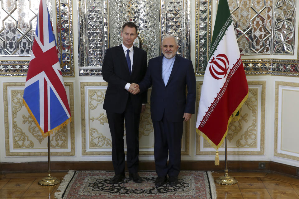 Iranian Foreign Minister Mohammad Javad Zarif, right, and Britain's Foreign Secretary Jeremy Hunt shake hands for the media prior to the start of their meeting in Tehran, Iran, Monday, Nov. 19, 2018. (AP Photo/Vahid Salemi)