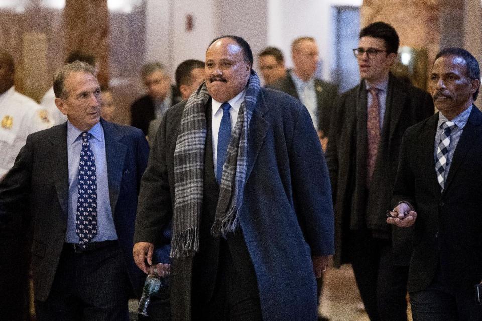 Martin Luther King III, son of Martin Luther King Jr., center, arrives at Trump Tower in New York, Monday, Jan. 16, 2017. (AP Photo/Andrew Harnik)