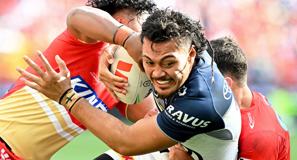 Seen here, Cowboys back-rower Jeremiah Nanai is tackled by Dolphins players in their NRL round one match. 