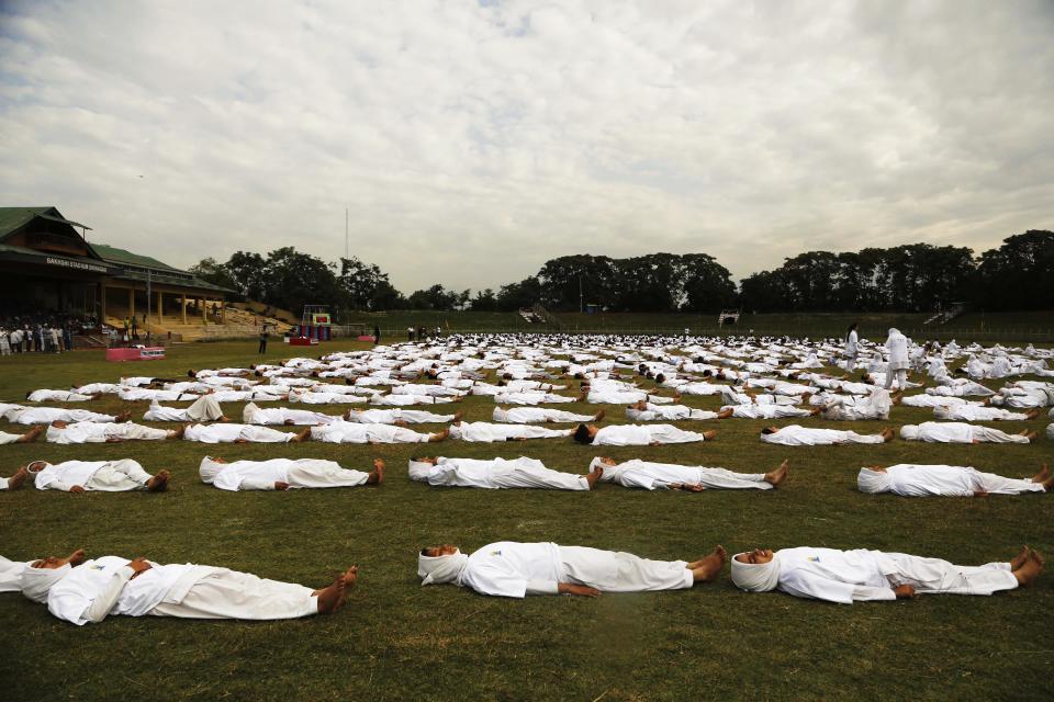Kashmiri students perform yoga as they mark International Yoga Day in Srinagar, Indian controlled Kashmir, Sunday, June 21, 2015. Millions of yoga enthusiasts across the world bent and twisted their bodies in complex postures Sunday to mark International Yoga Day. (AP Photo/Mukhtar Khan)