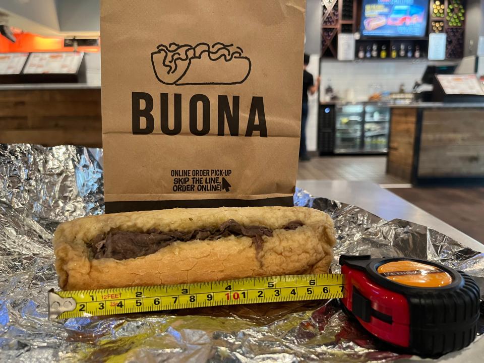 A tape measure next to a Buona Italian beef sandwich measuring 6 1/2 inches.