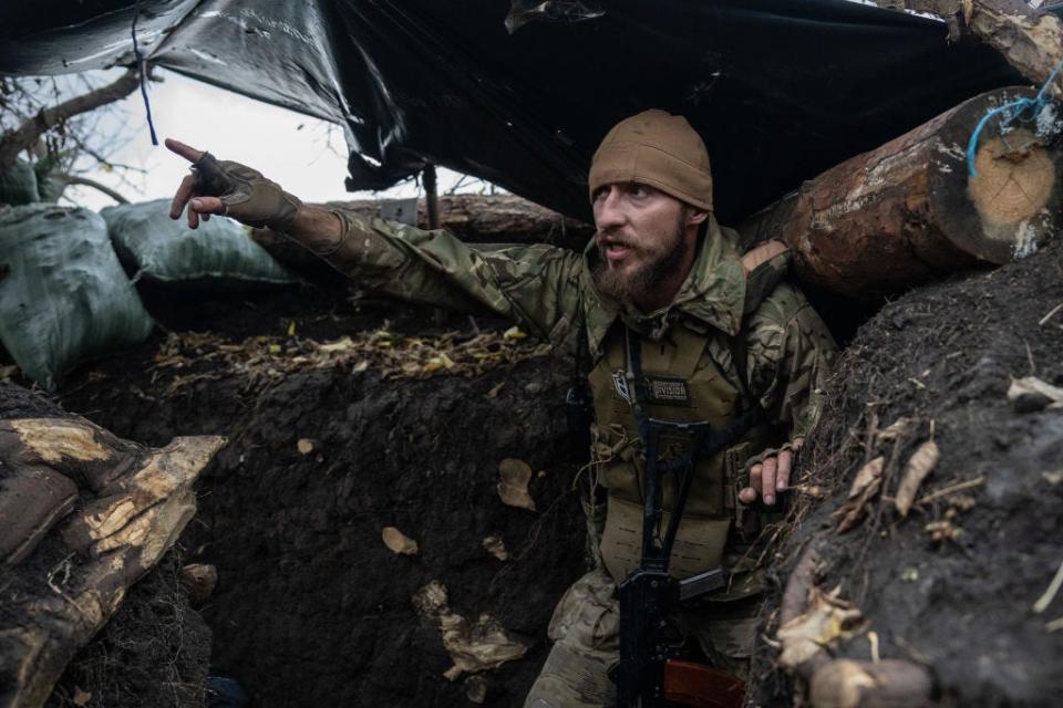 Slavian, a former Russian special forces sergeant who now fights for Ukraine after living in the country for a decade with his Ukrainian wife, gestures towards Russian positions around 150 metres away on October 27, 2022 in Zaporizhzhia oblast, Ukraine.