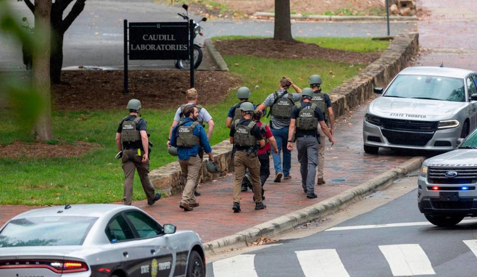 North Carolina ALE Agents exit the Caudill Laboratories building near the Bell Tower on the University of North Carolina campus after a report of an armed and dangerous person on Monday, August 28. 2023 in Chapel Hill, N.C. Tailei Qi, 34, a graduate student was arrested in the shooting at UNC-Chapel Hill on Monday that left a member of the faculty dead and put the entire campus on lockdown for more than three hours.