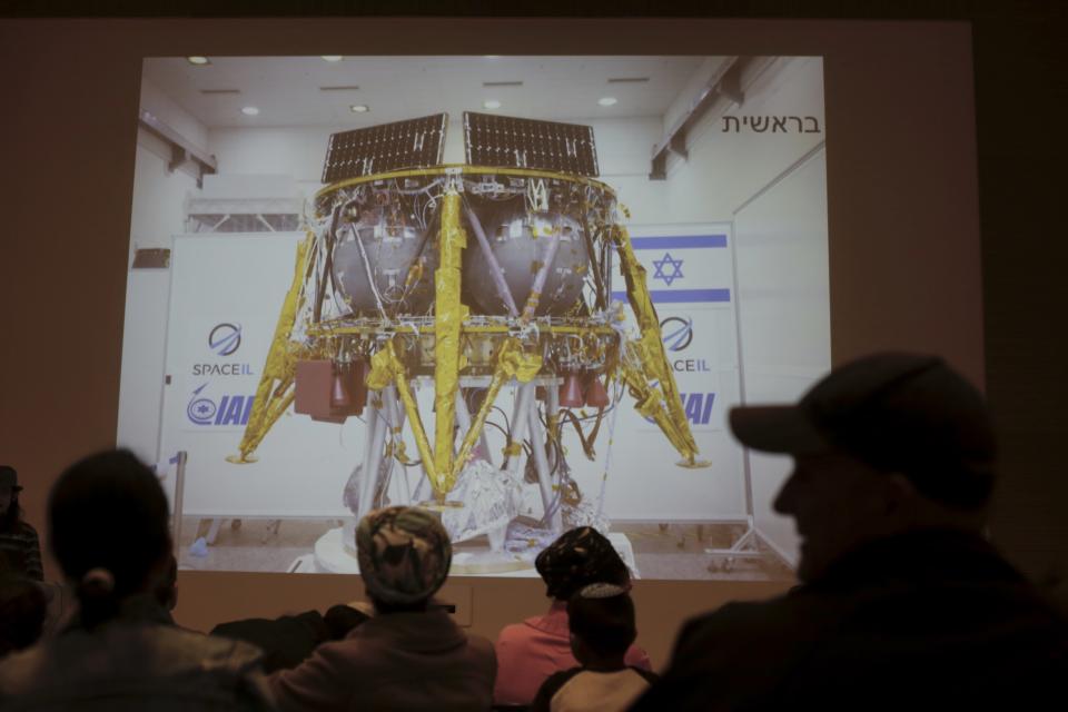 People watch the live broadcast of the SpaceIL spacecraft as it lost contact with Earth in Netanya, Israel, Thursday, April 11, 2019. An Israeli spacecraft has failed in its attempt to make history as the first privately funded lunar mission.The SpaceIL spacecraft lost contact with Earth late Thursday, just moments before it was to land on the moon, and scientists declared the mission a failure. (AP Photo/Ariel Schalit)