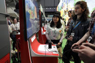 Visitors to the Pax East conference play the new Nintendo Switch video game Animal Crossing, Thursday, Feb. 27, 2020, in Boston. Thousands of gaming enthusiasts attended the Pax East conference that opened in Boston, Thursday. (AP Photo/Steven Senne)