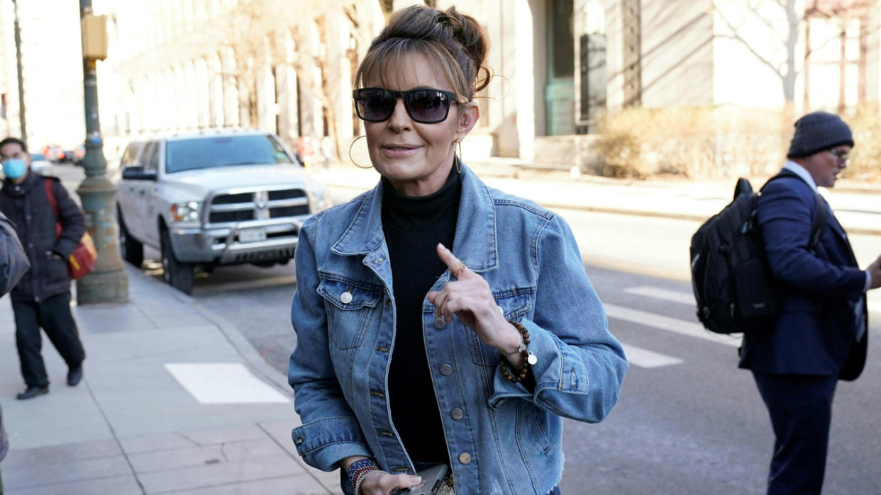 Former Alaska Governor Sarah Palin raises a finger as if to make a point as she arrives at a federal court in Manhattan. (Timothy A. Clary/AFP via Getty Images)