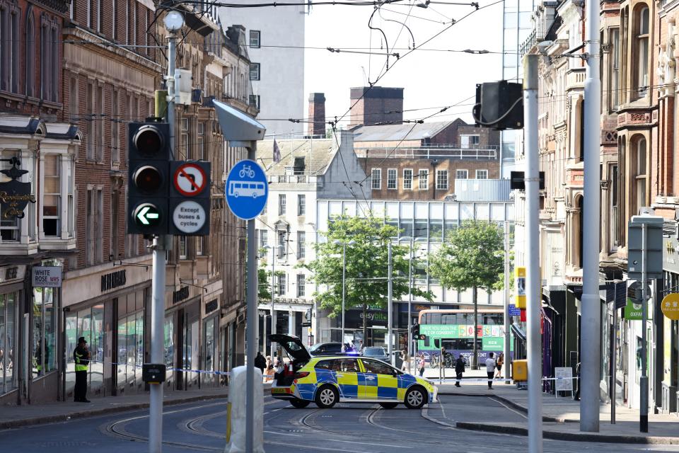 A police officer stands by a cordon outside on Market Street in Nottingham, central England, during a 'major incident' in which three people have been found dead. UK police on Tuesday locked down the central English city of Nottingham after three people were found dead in a 