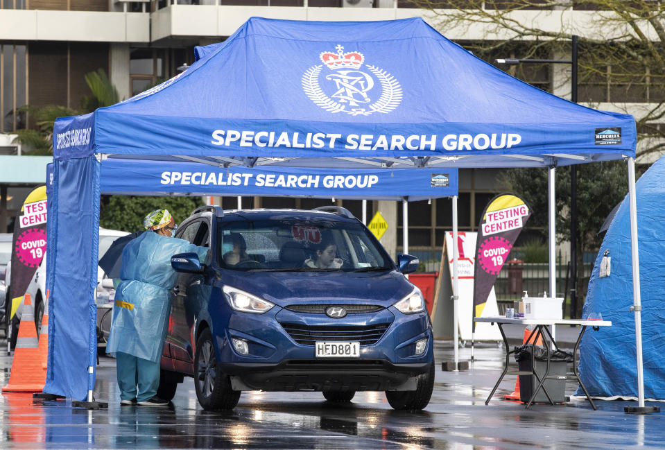 Medical staff test residents of South Auckland at a pop up Covid-19 testing centre in the Otara Mall, in Auckland, as New Zealand prepares to move into Covid-19 Alert Level 3, Wednesday, Aug. 12, 2020. New Zealand Prime Minister Jacinda Ardern said Tuesday, Aug. 11 authorities have found four cases of the coronavirus in one Auckland household from an unknown source, the first reported cases of local transmission in the country in 102 days. (Greg Bowker/New Zealand Herald via AP)