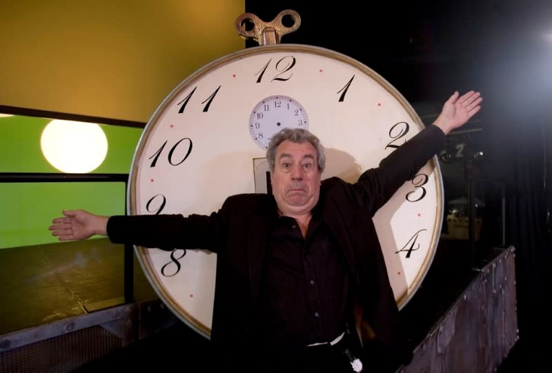 FILE PHOTO: Former Monty Python star Jones gestures in front of "time machine" before interview in Lisbon
