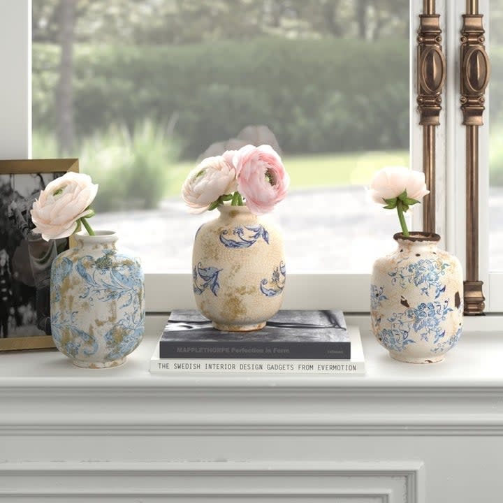 the white and blue round vases on a shelf