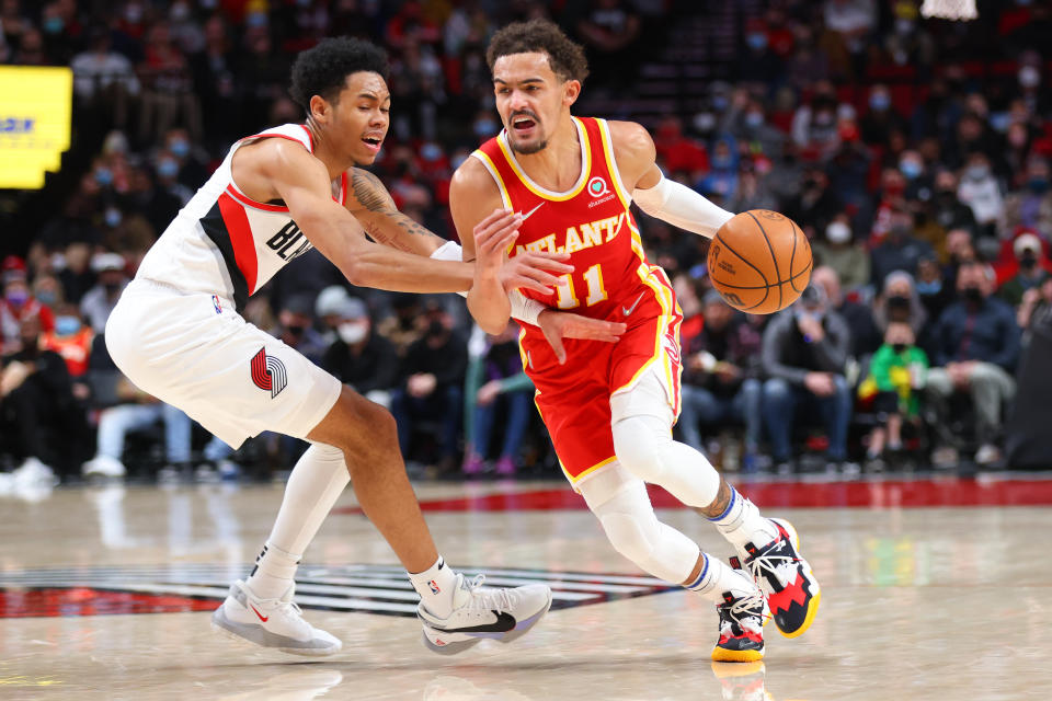 PORTLAND, OREGON - JANUARY 03: Trae Young #11 of the Atlanta Hawks works towards the basket against Anfernee Simons #1 of the Portland Trail Blazers during the second halfat Moda Center on January 03, 2022 in Portland, Oregon. NOTE TO USER: User expressly acknowledges and agrees that, by downloading and or using this photograph, User is consenting to the terms and conditions of the Getty Images License Agreement. (Photo by Abbie Parr/Getty Images)