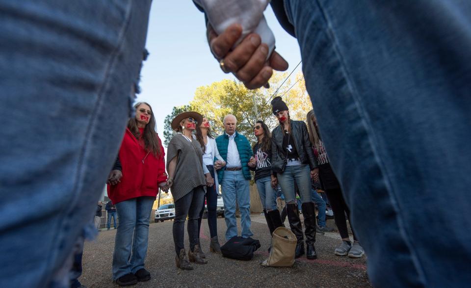 Anti-abortion advocates pray outside the Jackson Women's Health Organization in Jackson, Miss., Wednesday, Dec. 1, 2021.