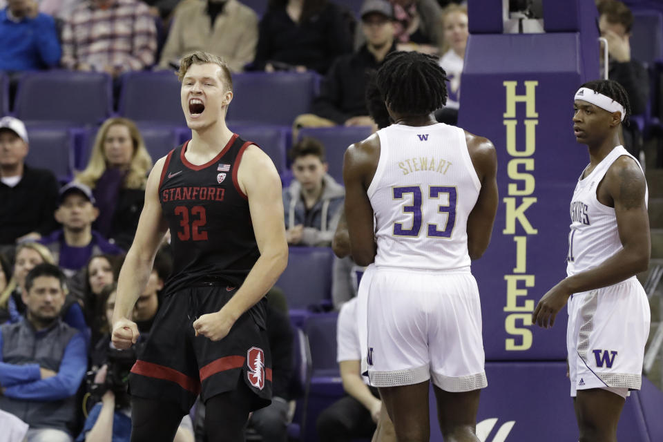 Stanford's Lukas Kisunas (32) reacts after scoring as Washington's Isaiah Stewart (33) and Nahziah Carter watch during the first half of an NCAA college basketball game Thursday, Feb. 20, 2020, in Seattle. (AP Photo/Elaine Thompson)