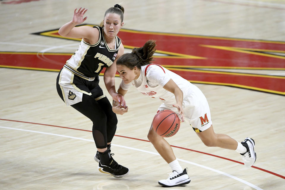 Maryland guard Katie Benzan (11) dribbles in front of Purdue guard Karissa McLaughlin (1) during the second half of an NCAA college basketball game, Sunday, Jan. 10, 2021, in College Park, Md. (AP Photo/Will Newton)