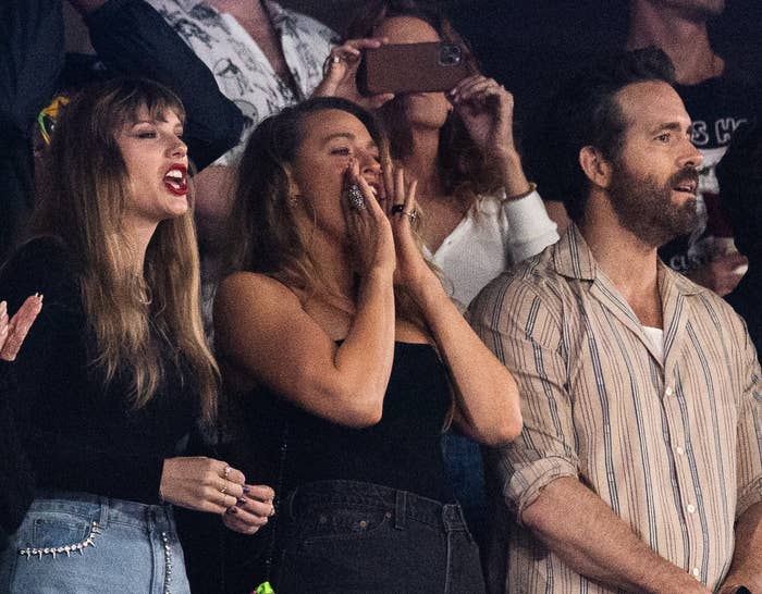 Taylor Swift, Blake Lively, Ryan Reynolds cheering at an event