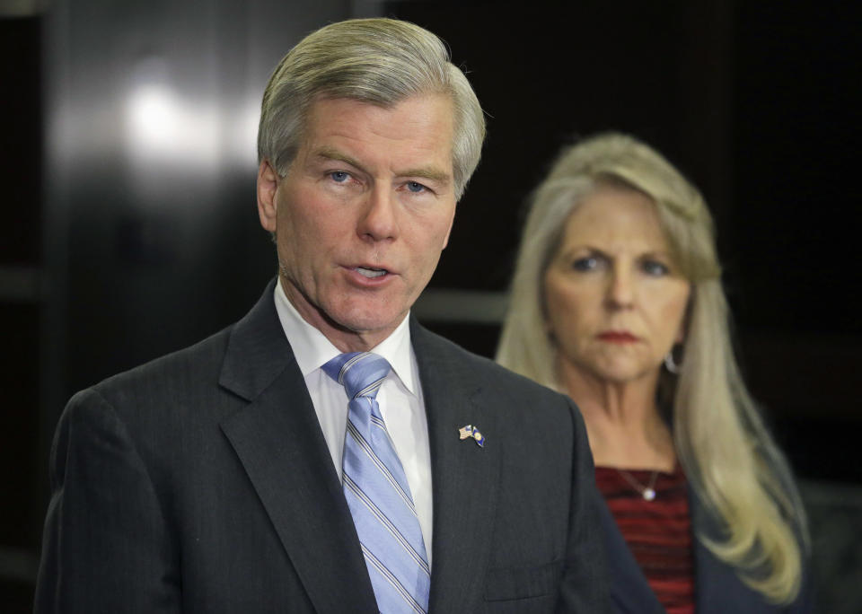 Former Virginia Gov. Bob McDonnell makes a statement as his wife, Maureen, listens during a news conference in Richmond, Va., Tuesday, Jan. 21, 2014. McDonnell and his wife were indicted Tuesday on corruption charges after a monthslong federal investigation into gifts the Republican received from a political donor. (AP Photo/Steve Helber)