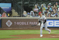 Los Angeles Angels' Shohei Ohtani watches his solo home run as he heads to first base during the second inning of a baseball game against the Seattle Mariners, Thursday, Aug. 6, 2020, in Seattle. (AP Photo/Ted S. Warren)