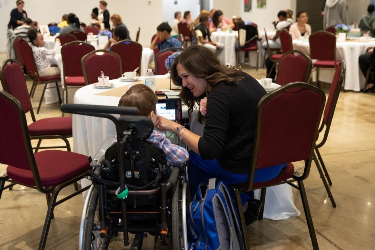 Mother of the Year recipient Erika Jenkins spends time with her eight-year-old son Evan at the awards event hosted by Lamb Center for Arts and Healing at Guncotton Coffee in downtown Hopewell, Va. on May 7, 2022.