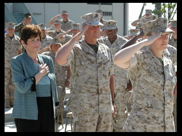 Claire Russo (front) salutes the flag during the national anthem, before she was given the "Citizen of Courage" award from the San Diego District Attorney's office in 2006.   Behind her is San Diego District Attorney Bonnie Dumanis and First Marine Expeditionary Force (IMEF) Commanding General John Sattler, who Russo says is the "only commander to ever apologize to me for what I experienced."