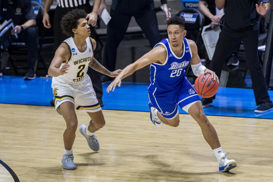 Drake's Jonah Jackson (20) drives against Wichita State's Craig Porter Jr. (2) in an NCAA tournament First Four game. (AP Photo/Robert Franklin)