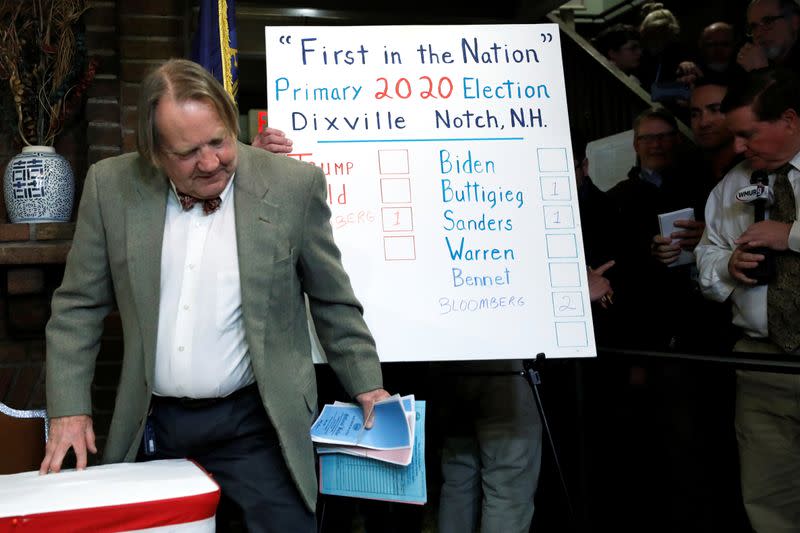 Town moderator Tom Tillotson carries ballots past the tally board shortly after midnight in the U.S. Democratic presidential primary at the Hale House at Balsams Hotel in Dixville Notch