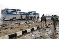 Indian soldiers examine the debris after an explosion in Lethpora in south Kashmir's Pulwama district February 14, 2019. REUTERS/Younis Khaliq