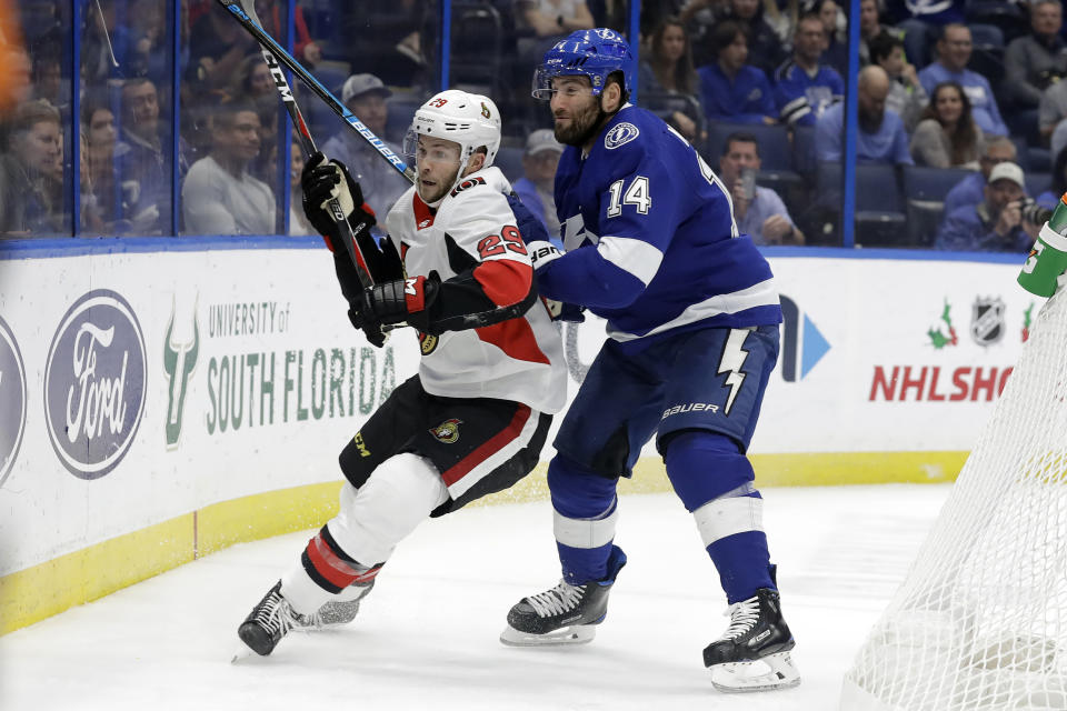 Tampa Bay Lightning left wing Pat Maroon (14) rides Ottawa Senators defenseman Cody Goloubef (29) into the boards during the second period of an NHL hockey game Tuesday, Dec. 17, 2019, in Tampa, Fla. (AP Photo/Chris O'Meara)