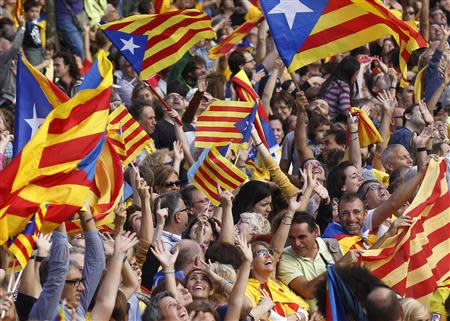 Catalan separatist flags are waved as a crowd forms a human chain to mark the "Diada de Catalunya" (Catalunya's National Day) in central Barcelona September 11, 2013. REUTERS/Albert Gea