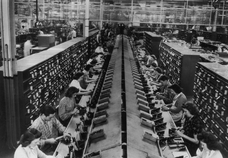 Workers assembling control units for tanks and aircraft in a US factory, circa 1943