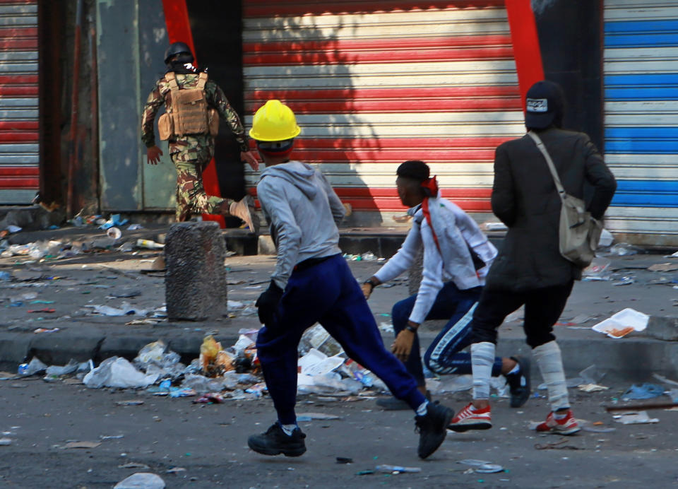 Protesters chase a soldier during clashes between security forces and anti-government protesters on Rasheed Street in Rasheed Street, Baghdad, Iraq, Tuesday, Nov. 26, 2019. (AP Photo/Khalid Mohammed)