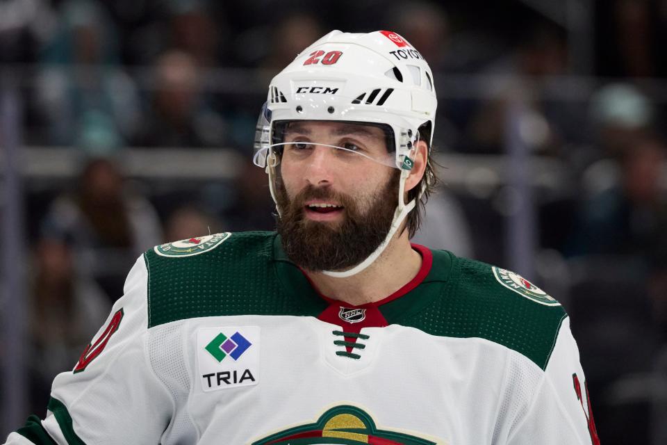 Minnesota Wild left wing Pat Maroon (20) smiles as he skates on the ice waiting for a face off against the Seattle Kraken during the third period of an NHL hockey game, Sunday, Dec. 10, 2023, in Seattle. The Wild won 3-0. (AP Photo/John Froschauer)