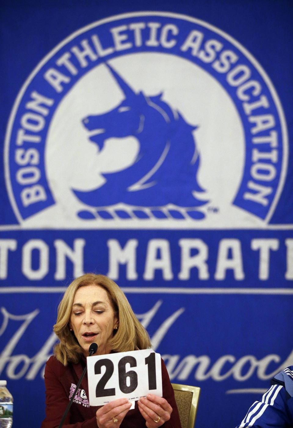 Kathrine Switzer holds up her original Boston Marathon bib number.