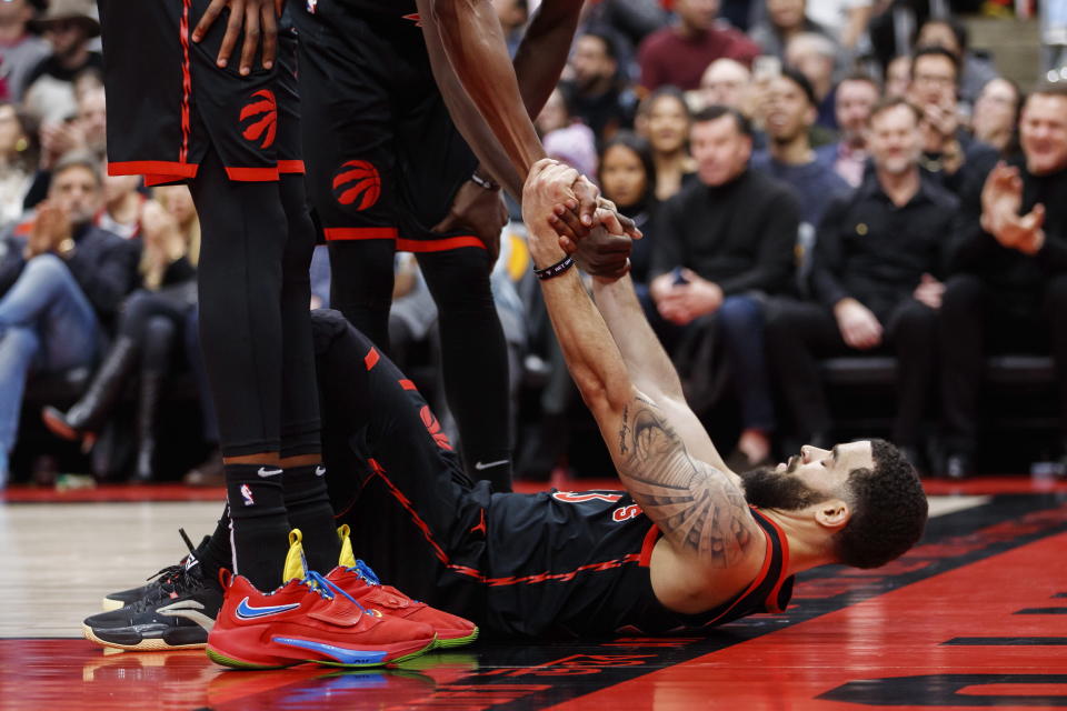 Toronto Raptors guard Fred VanVleet (23) is picked up by teammates during the first half of an NBA basketball game against the Brooklyn Nets in Toronto, Friday, Dec. 16, 2022. (Cole Burston/The Canadian Press via AP)