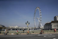 Una familia cruza el Puente de Westminster en Londres en bicicleta el 10 de abril del 2020. La pandemia de coronavirus está dando nuevo impulso a las bicicletas como alternativa al trasporte público. (AP Photo/Matt Dunham, File)