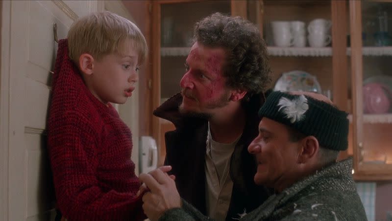 Macaulay Culkin is threatened by burglars Daniel Stern, center, and Joe Pesci in the holiday slapstick farce “Home Alone” (1990).